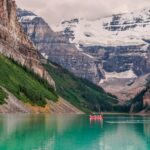 Picturesque canoeing at Lake Louise, surrounded by stunning Rocky Mountains.